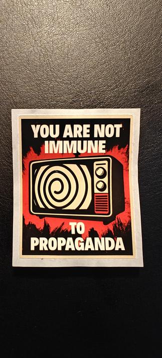 Rectangle sticker, with a old TV on it and the words "you are not immune to Propaganda"